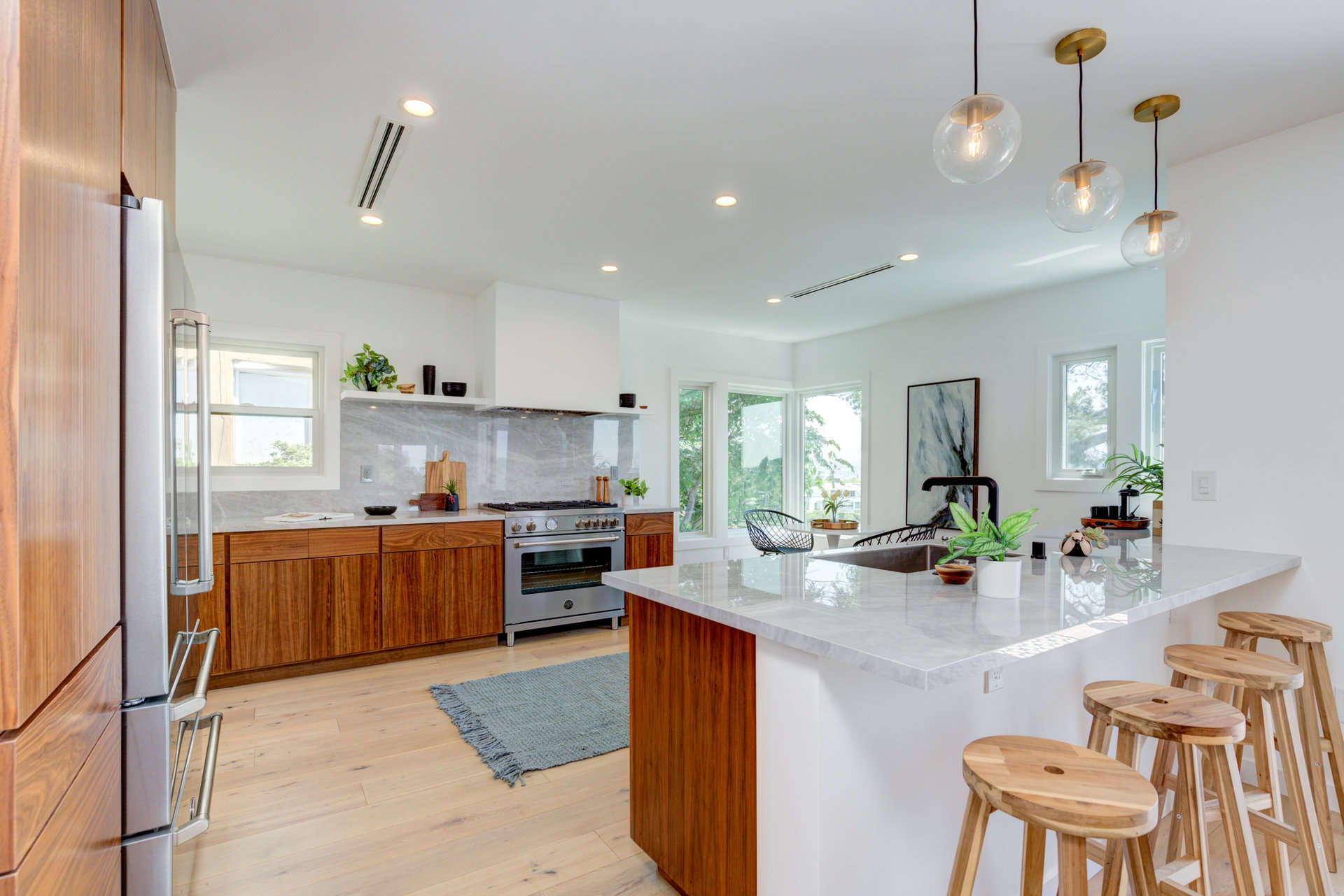 Newly remodeled kitchen with hardwood floors and stylish fixtures