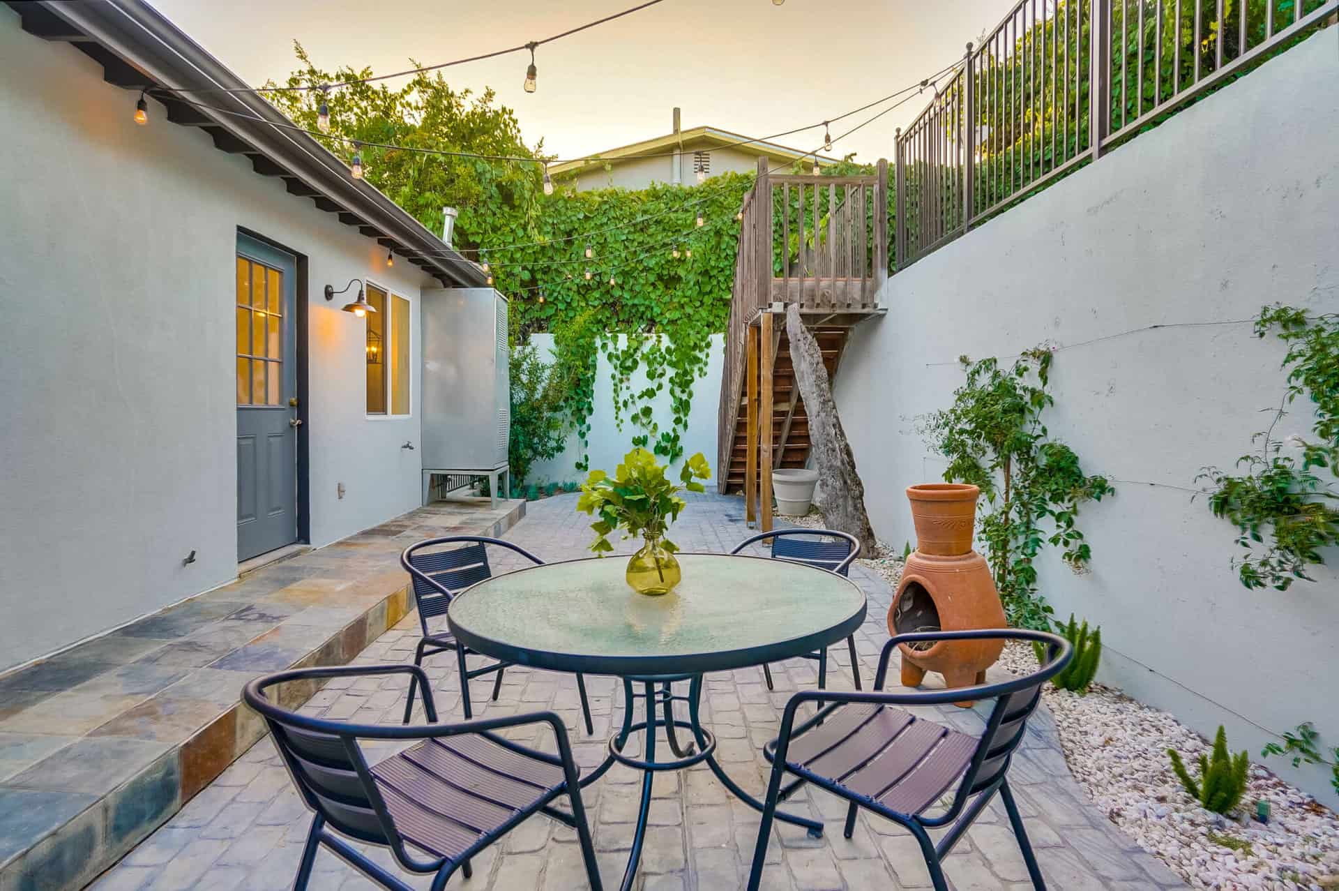 Outdoor patio space with glass table and chairs for entertaining